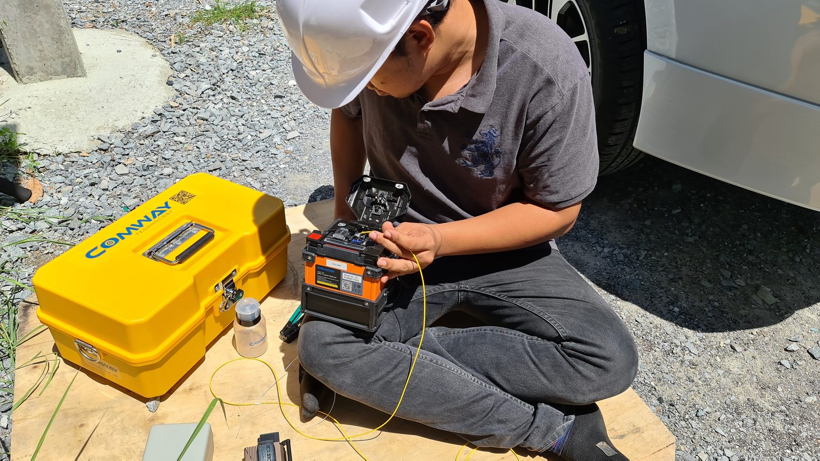 Fusion splicer working closeup \u2014 Titan Networks Fiber